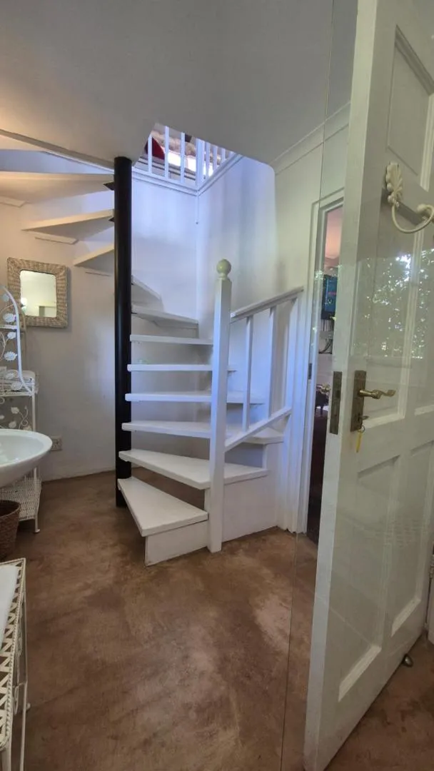 The narrow white staircase to the loft