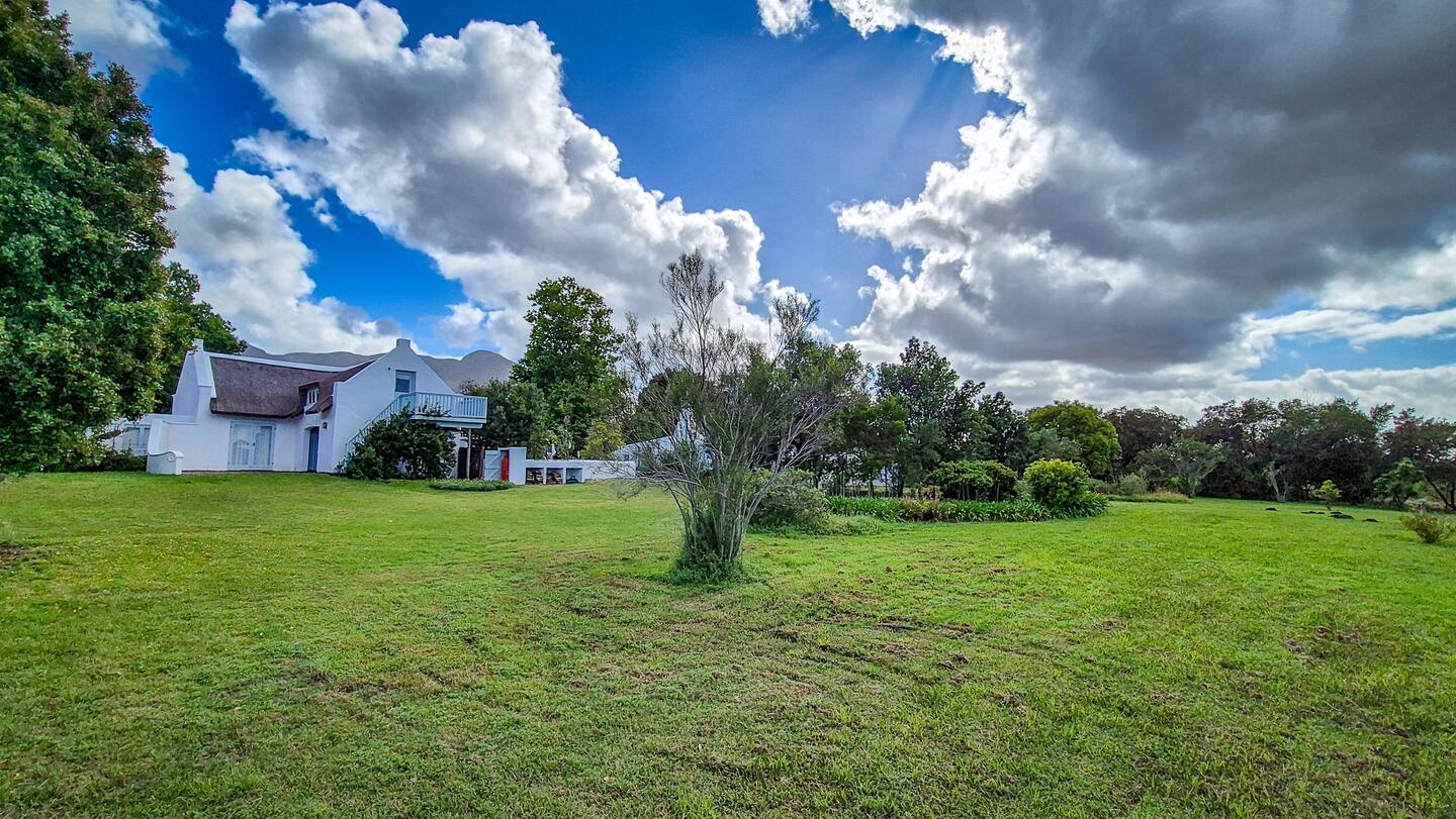 Open lawn and the house seen from the reserve