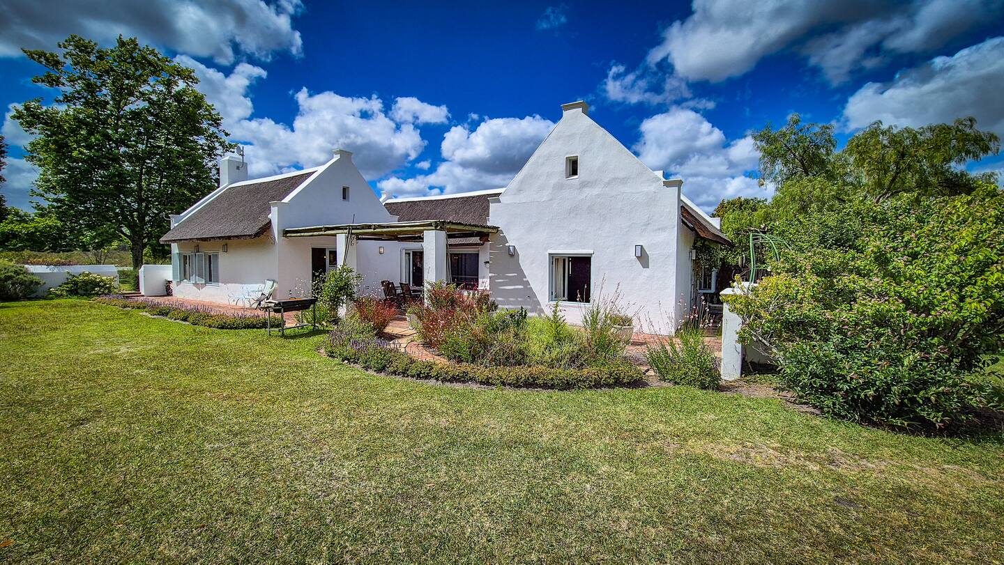 Garden side of the house with the braai on the lawn
